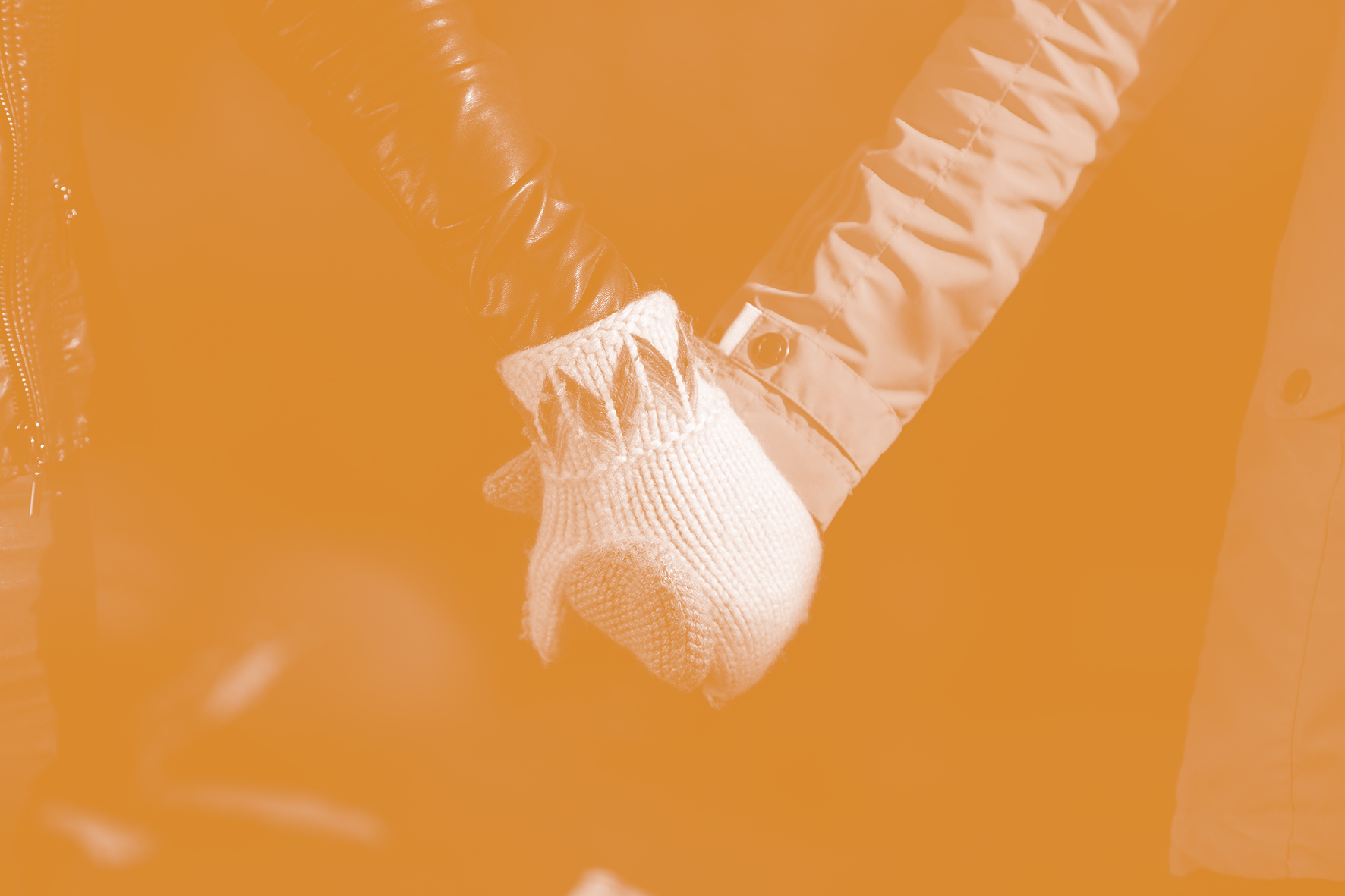 Students holding hands while wearing mittens.